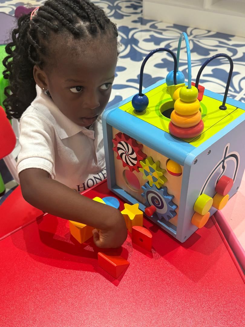 Young learner exploring a sensory activity toy